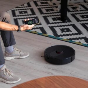 Smart Home Robot Vacuum Cleaner with Mop & Automatic Dust Collection, black color, cleaning floors and mopping surfaces.